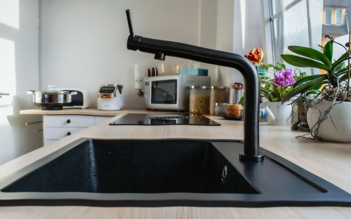 Perknomad carpenter fitting kitchen cabinetry in a Perth home